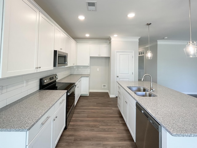 kitchen with stainless steel appliances, white cabinetry, and pendant lighting