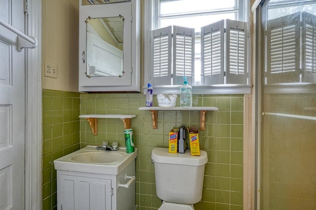 bathroom with tile walls, backsplash, toilet, and vanity