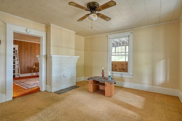 carpeted spare room with ceiling fan and ornamental molding