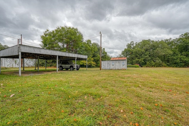 view of yard with a storage unit and a carport