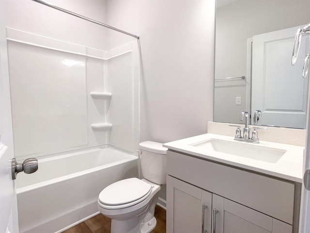 full bathroom with vanity, hardwood / wood-style floors, tub / shower combination, and toilet