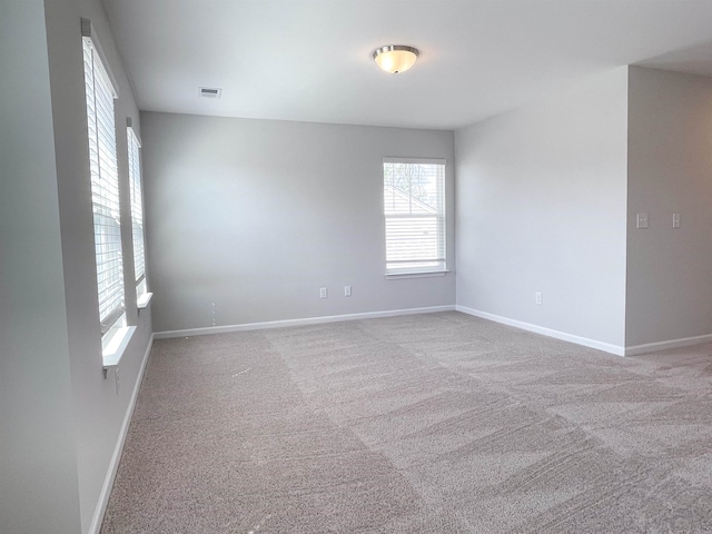 empty room featuring light carpet