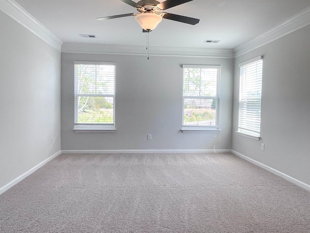 spare room with ceiling fan, light colored carpet, and ornamental molding