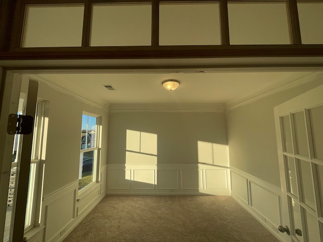 carpeted empty room featuring ornamental molding