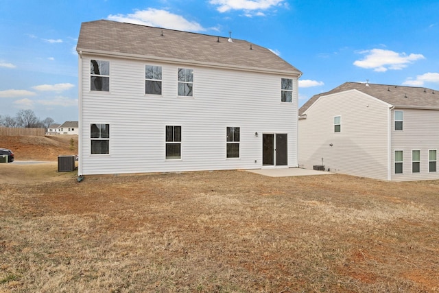 back of house featuring a patio, central air condition unit, and a lawn