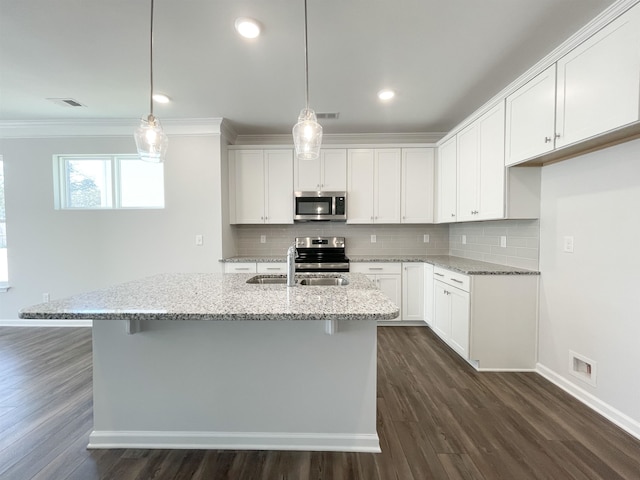 kitchen with dark hardwood / wood-style floors, stainless steel appliances, white cabinets, and light stone counters