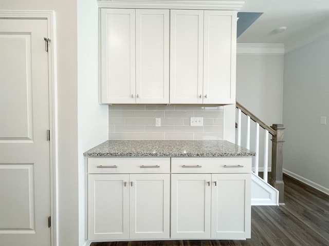 kitchen featuring crown molding, tasteful backsplash, dark hardwood / wood-style floors, and white cabinets