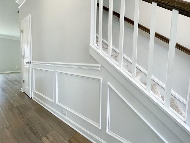 corridor featuring crown molding and dark hardwood / wood-style floors