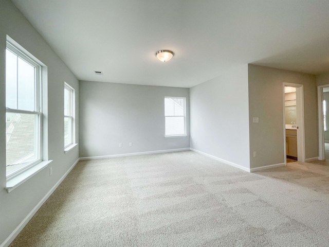 spare room with light colored carpet