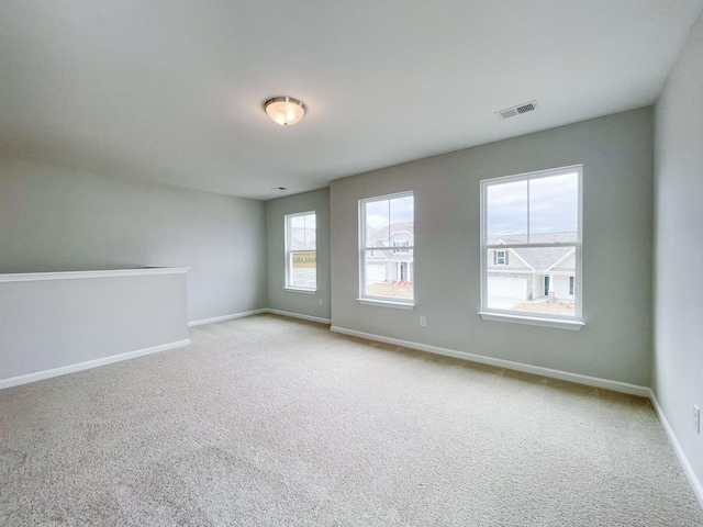 carpeted spare room with a healthy amount of sunlight