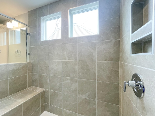 bathroom with a tile shower