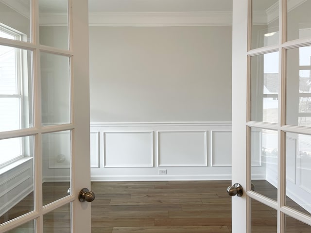 interior space with a healthy amount of sunlight, french doors, and crown molding