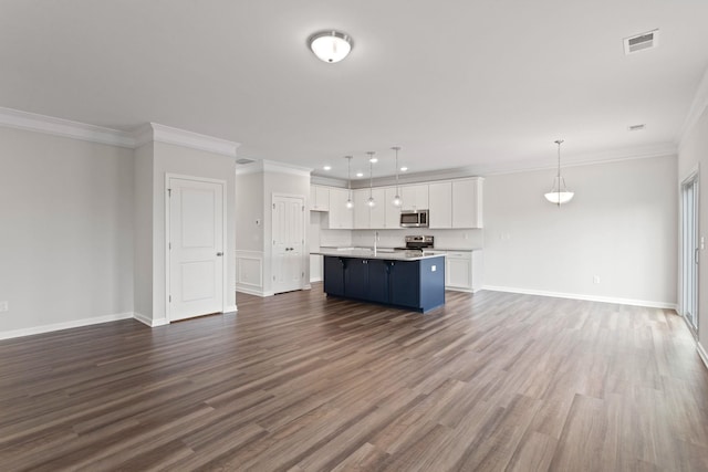 unfurnished living room with visible vents, dark wood-type flooring, baseboards, and ornamental molding