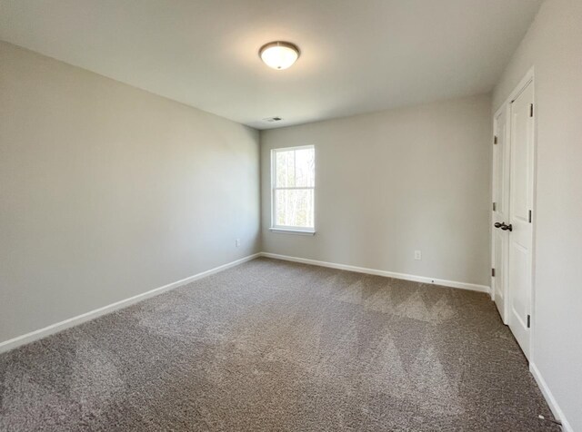 unfurnished room featuring carpet