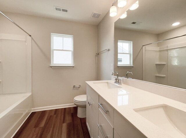 bathroom with vanity, hardwood / wood-style floors, and toilet