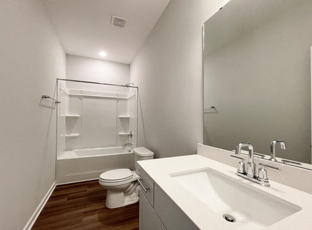 full bathroom with vanity, hardwood / wood-style floors, shower / tub combination, and toilet