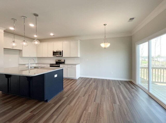 kitchen featuring pendant lighting, sink, crown molding, white cabinetry, and stainless steel appliances