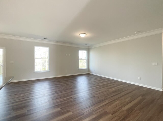 unfurnished room with dark wood-type flooring and ornamental molding