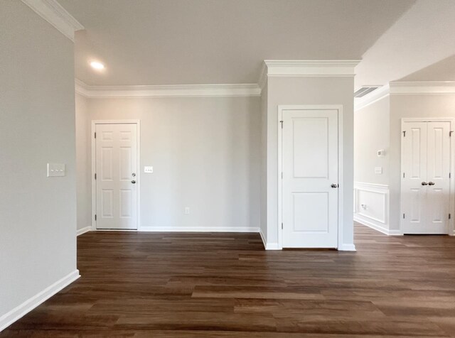 spare room with dark hardwood / wood-style flooring and ornamental molding