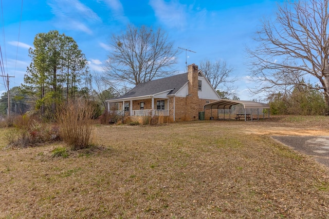 view of front of home featuring a carport, covered porch, and a front lawn