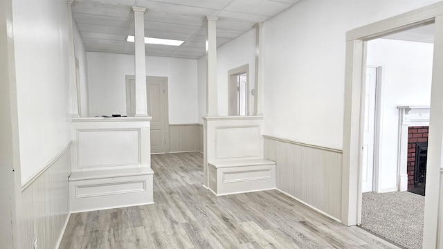 hall featuring light colored carpet and a paneled ceiling