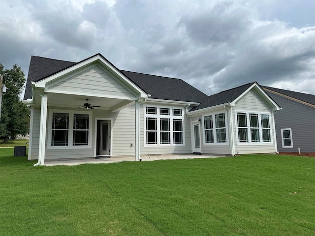 rear view of property with a patio, ceiling fan, and a lawn