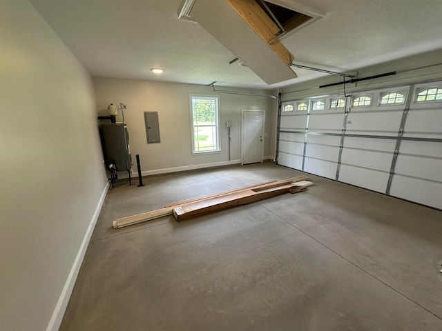 garage with electric water heater and electric panel