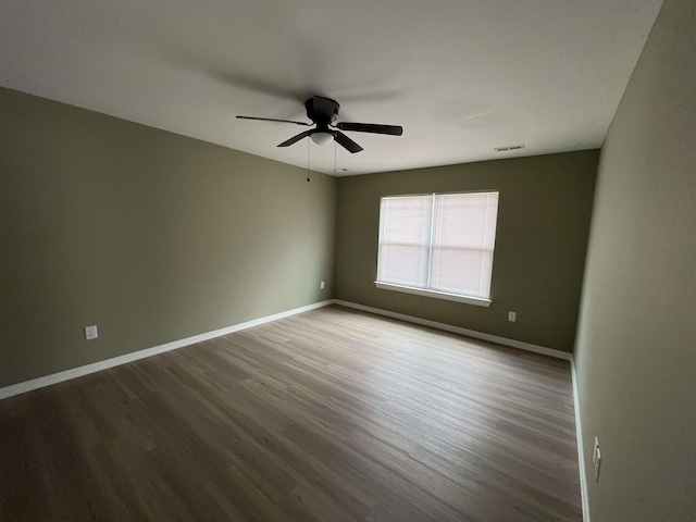 spare room with ceiling fan and wood-type flooring