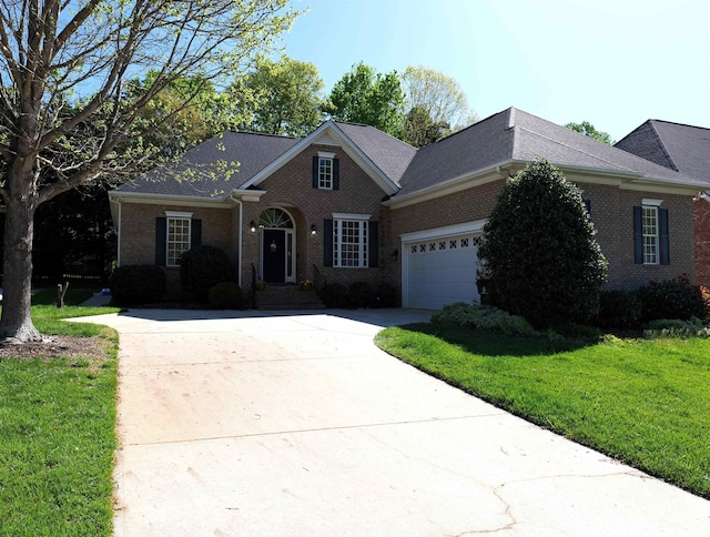 view of front of property featuring a front lawn, concrete driveway, brick siding, and an attached garage