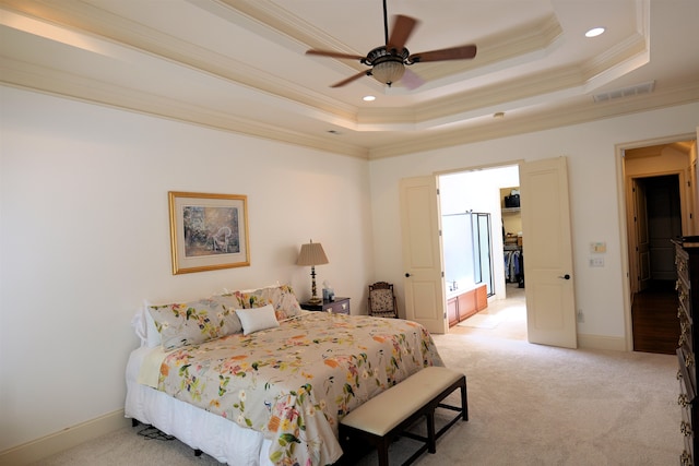 bedroom featuring light colored carpet, visible vents, baseboards, ornamental molding, and a raised ceiling