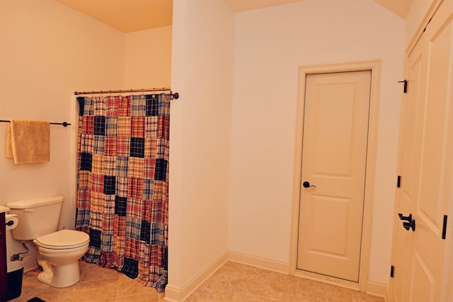 full bathroom featuring toilet, baseboards, and tile patterned floors