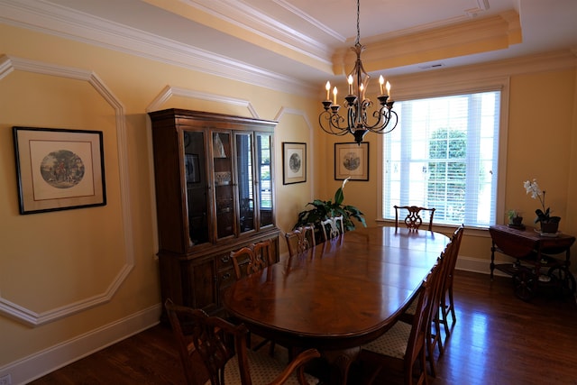 dining room featuring dark wood-style floors, crown molding, a raised ceiling, and an inviting chandelier