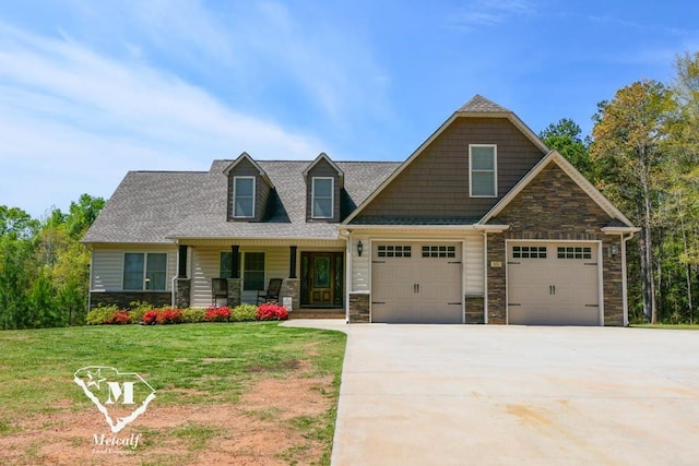 view of front of home featuring a front yard, a garage, and covered porch