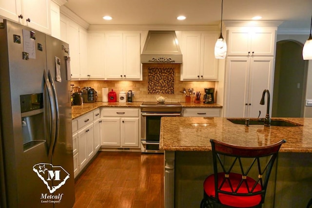 kitchen with premium range hood, hanging light fixtures, light stone countertops, dark hardwood / wood-style floors, and stainless steel appliances