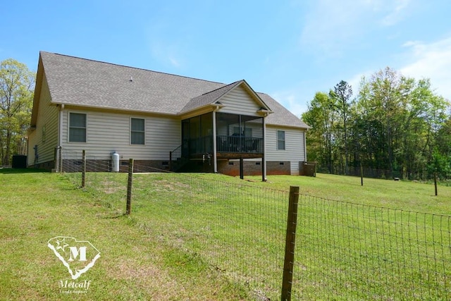 back of property featuring a yard and a sunroom