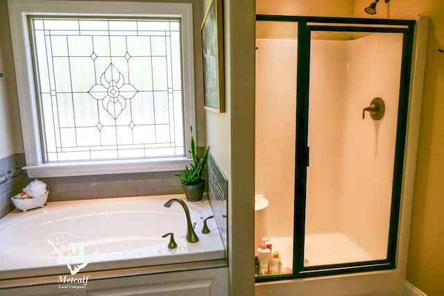 bathroom with independent shower and bath and plenty of natural light