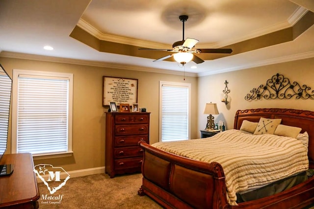 carpeted bedroom with ornamental molding, ceiling fan, and a raised ceiling