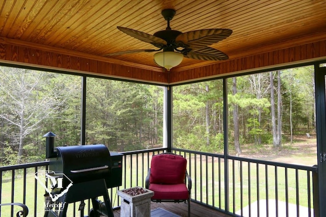 unfurnished sunroom with wooden ceiling, ceiling fan, and a wealth of natural light