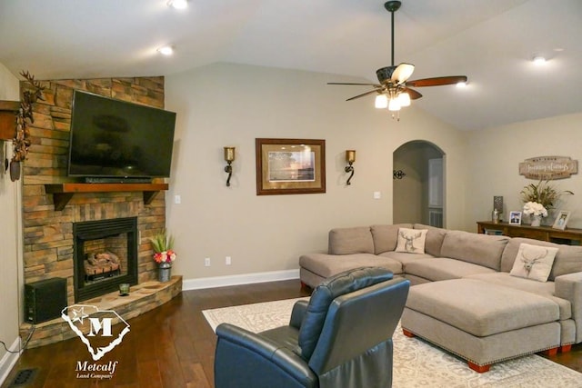 living room featuring dark hardwood / wood-style flooring, a fireplace, ceiling fan, and lofted ceiling