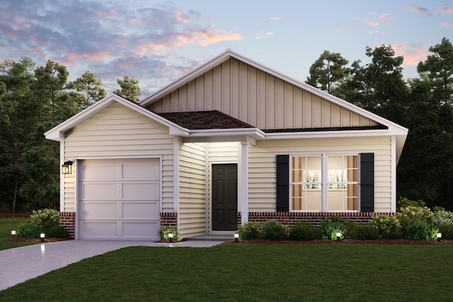 view of front of home with a garage and a lawn