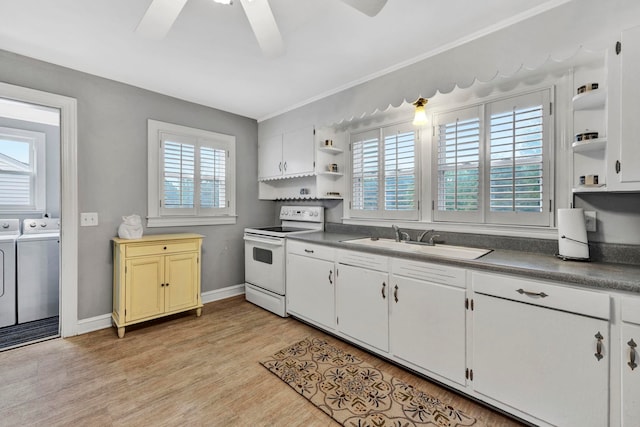 kitchen featuring white electric range, ceiling fan, light hardwood / wood-style floors, washer and dryer, and sink