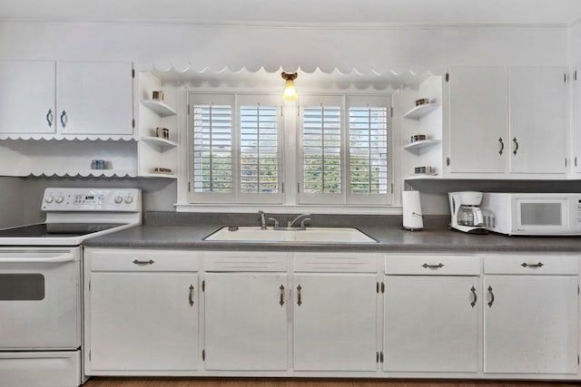 kitchen with white cabinetry, hardwood / wood-style floors, white appliances, and sink