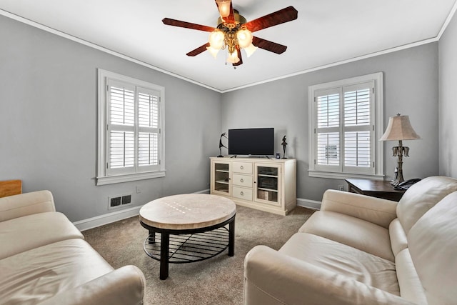 carpeted living room featuring ornamental molding and ceiling fan