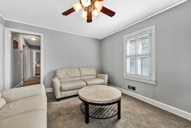 carpeted living room featuring ornamental molding and ceiling fan