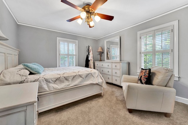 bedroom with ornamental molding, ceiling fan, and carpet flooring