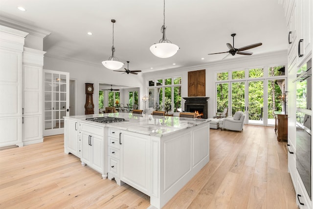 kitchen featuring white cabinetry, light hardwood / wood-style floors, and ceiling fan