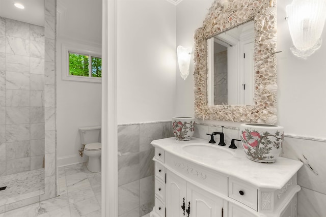 bathroom featuring tile walls, a shower, large vanity, toilet, and tile flooring