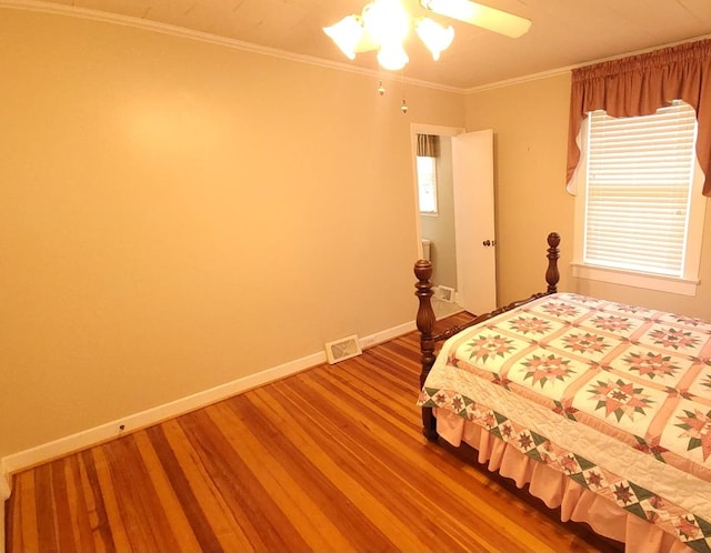 bedroom featuring wood-type flooring, ceiling fan, crown molding, and multiple windows