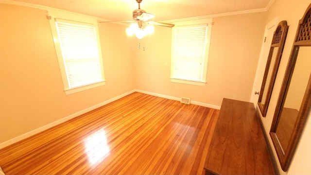 unfurnished bedroom with ceiling fan, hardwood / wood-style flooring, and ornamental molding