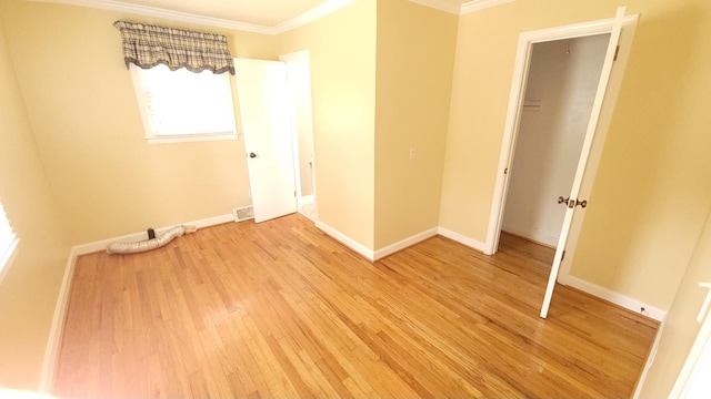 unfurnished bedroom with light hardwood / wood-style floors and crown molding